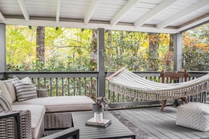 Screened-in porch nestled in nature.