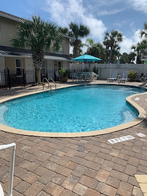 Heated Pool with lounge chairs and dining tables 