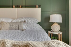Indulge in comfort in our master bedroom, boasting a chic board and batten wall, a heavenly memory foam mattress, and luxurious bedding for a restful retreat.
