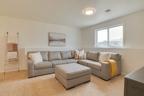 Sink in to our inviting family room, featuring a large sectional and ottoman adorned with down feather accent pillows.  Perfect for unwinding after a long day!