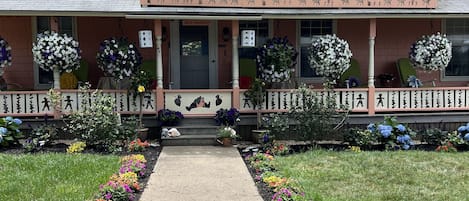 Front of gingerbread home with beautiful flower landscaping Spring time