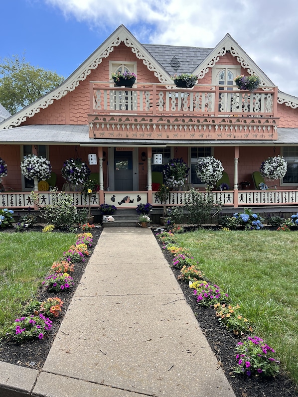 Front of gingerbread home with beautiful flower landscaping Spring time