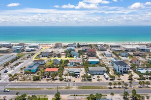 aerial view showcases the prime location of this home, nestled just 600 feet from the pristine shores of the Gulf of Mexico. Experience the ultimate seaside retreat.