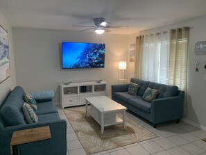 Living room with sleeper sofa and 65” tv