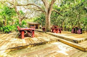 Rustic haven with weathered wood, quaint porch, lantern, and nature' embrace.