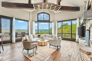 Relax in style while taking in stunning panoramic views from the comfort of this beautifully designed living room, complete with large windows and cozy seating