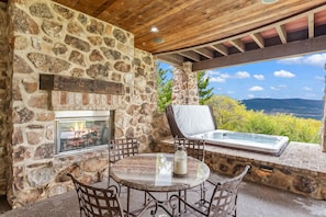 Unwind in your private hot tub while enjoying the warmth and charm of the nearby fireplace—a perfect combination for ultimate relaxation under the stars