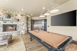 Challenge friends and family to a game of pool in this stylish game room, perfect for creating memories and enjoying endless entertainment.