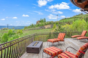 Gather on the spacious deck, complete with a warm and inviting fireplace, while taking in the fresh mountain air and stunning views.