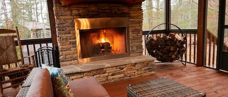 Fully screened in Outdoor side patio with wood burning Fireplace (non propane)