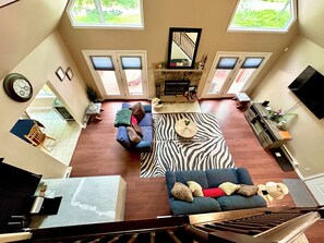 Open floor Living room with Reclining soft sofa, Fire place and TV