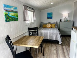 Standard bed with linens and towels included, dining table and kitchenette