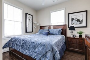 Master bedroom with a king sized bed, dresser space for your belongings and a flat-screen Roku TV.