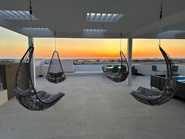 Enjoy magical sunsets over the lagoon and beach from the rooftop deck