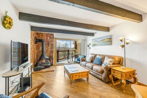 Open living area with fireplace and TV