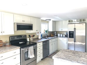Kitchen w/ range, microwave, fridge, dishwasher, nespresso and coffee maker