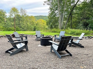 Smokeless firepit surrounded with Adirondack chairs 