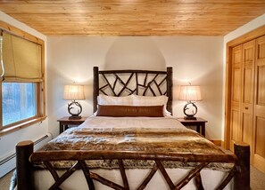 Lower level bedroom with gorgeous custom hickory bed