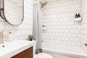 Refresh and rejuvenate in the stylish bathroom of The Gastown Loft, where modern amenities blend with eclectic design. Perfectly situated for exploring Stratford’s historical downtown, galleries, and the picturesque Lake Victoria