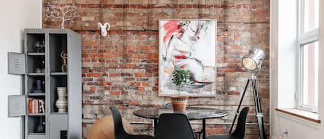 Discover urban elegance in our SoHo Loft's living area, bathed in natural light and enriched with art from around the globe. A stone's throw from Stratford's Avon Theatre and vibrant dining scene, it's an urban creative's dream