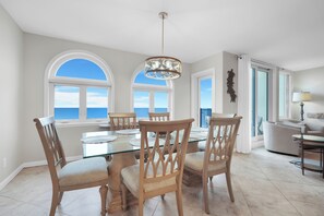 Oceanfront Dining Space with Glass Topped Table Seating Six