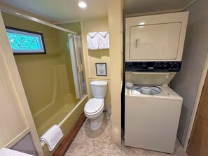 Bathroom with a shower/tub combo and washer/dryer for convenience