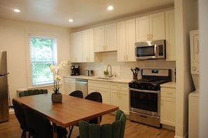 Kitchen and dining area with granite countertop and stainless appliances