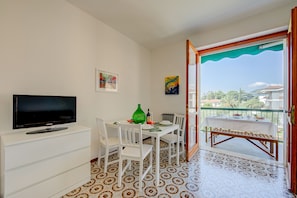 Living room with dining table, sofa bed and smart tv