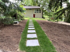 Ample street parking, paver path to the red door