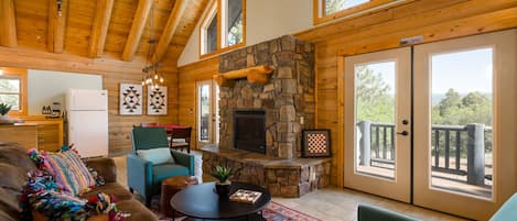 Main living area w/ kitchen, dining, and porch in the background