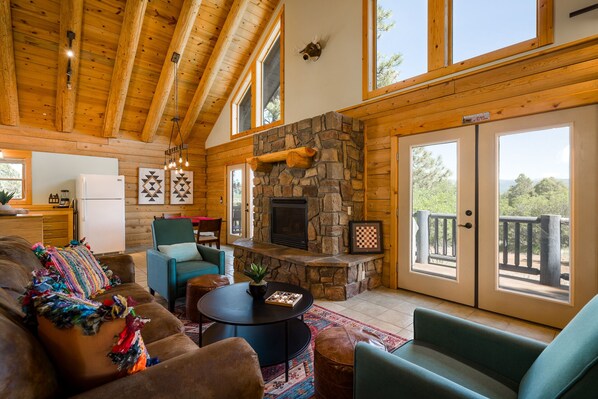 Main living area w/ kitchen, dining, and porch in the background