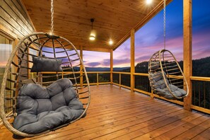 Two hanging swing chairs on the upper deck