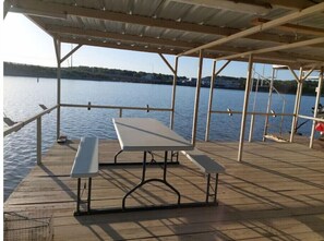 Boat dock  with plenty of fish pole holders, dining table, gas bbq