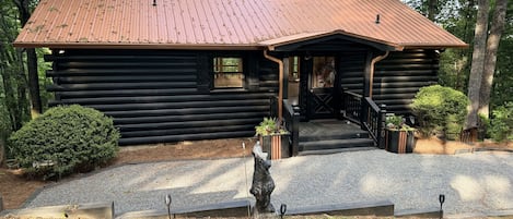 A Rustic Hideout! The front entrance beckons travelers and explorers alike, promising a warm and cozy shelter amidst the wild outdoors.