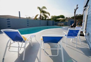 Sun-lounging poolside with the options of BBQ'n and shaded outdoor dining.