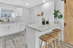 Fully equipped with modern appliances and plenty of counter space.