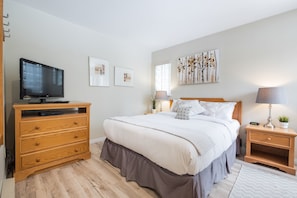 Peaceful and private primary bedroom features a queen bed, cable TV and an ensuite bathroom.