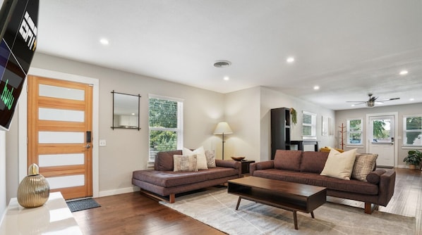 Open concept living room with large smart tv