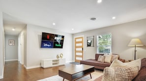 Open concept living room with large smart tv