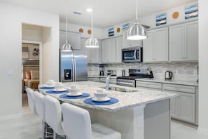 Kitchen featuring a convenient breakfast bar, offering a stylish and casual dining space for quick meals or socializing while preparing food.