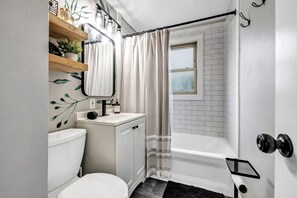 Subway tile shower.  Towels, toilet paper & hair dryer provided. 