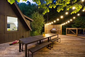 Dreamy outdoor deck vibes ✨🍽️ Dine under the string lights, grill out, and soak in the forest views 🌲 #VacationRentalVibes #OutdoorDining #DeckGoals #EveningMagic