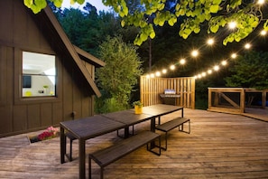 Dreamy outdoor deck vibes ✨🍽️ Dine under the string lights, grill out, and soak in the forest views 🌲 #VacationRentalVibes #OutdoorDining #DeckGoals #EveningMagic