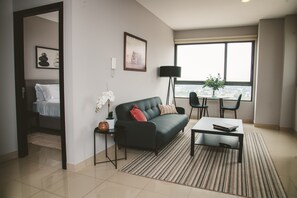 A versatile and cozy nook in the apartment, perfect for unwinding with a TV, enjoying meals at the table, working, or settling down with a good book