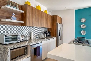 The fully-equipped kitchen features an oven, stove and dishwasher