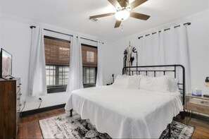 Kind size bed, with luxurious linens, robes, and an oscillating fan.