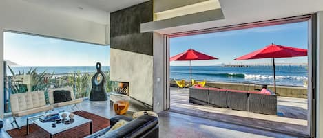 Living Room with panoramic ocean views~ a fireplace~ and a TV.