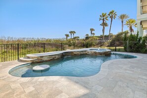 Incredible pool with Swim-up table, bench, waterfall feature and spa.