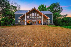 Welcome to your ultimate retreat! This stunning cabin, with its grand design and natural stone accents, is surrounded by nature’s beauty and offers the perfect blend of comfort and luxury for