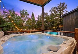Soak in the warm, bubbling hot tub while taking in the peaceful forest views, perfect for unwinding after a day of exploring.